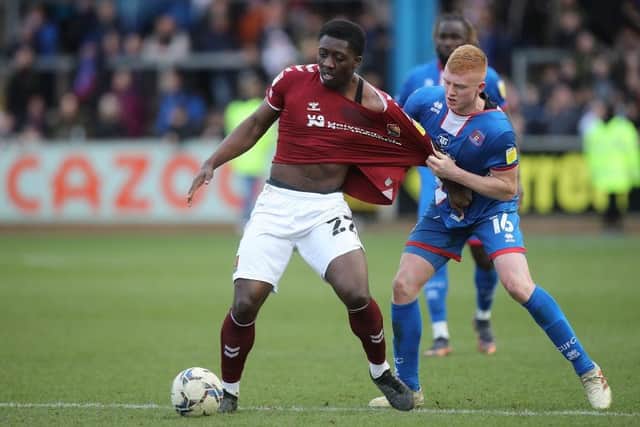 Benny Ashley-Seal of Northampton Town attempts to control the ball under pressure from Morgan Feeney of Carlisle United. (Photo by Pete Norton/Getty Images).