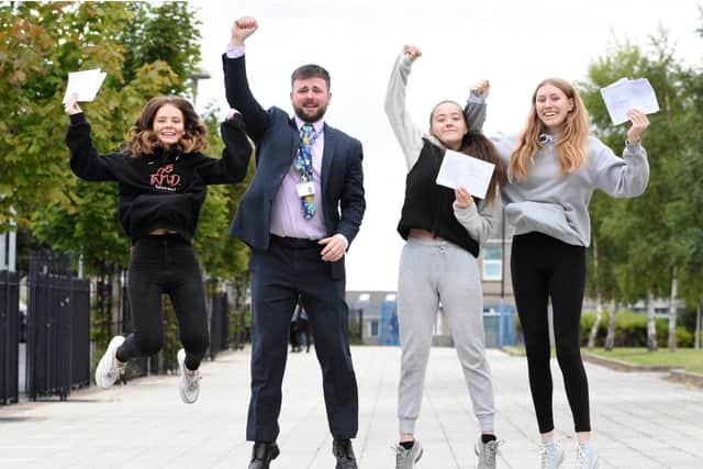 Washington Academy pupils Natasha Lamb, Katie Revell and Eleni Baker celebrate their GCSE results with deputy head teacher Liam Clark.