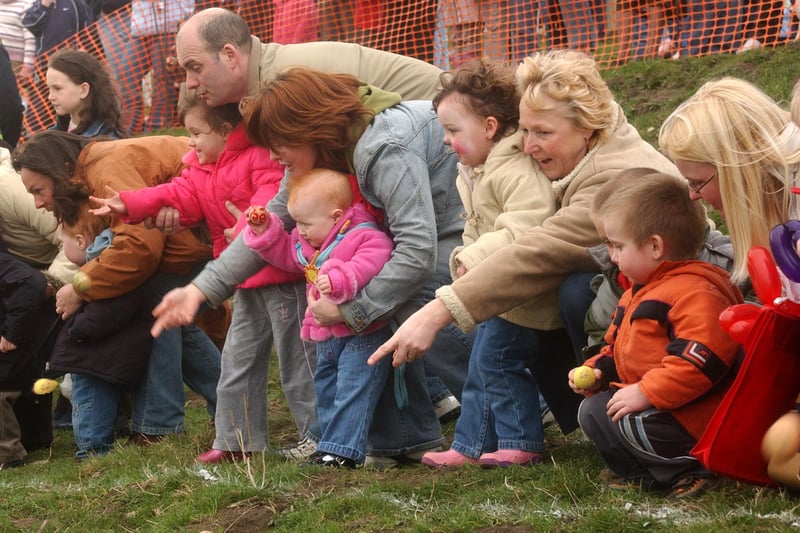 A scene from the 2005 Penshaw Bowl where children roll their eggs down a hill near Penshaw Monument. Can you spot someone you know?
