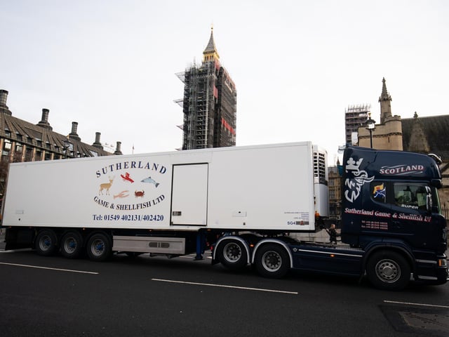 A lorry from Sutherland Game and Shellfish passes in front of the Houses of Parliament. Reports suggest that produce which has made it across the Channel has gone rotten by the time it arrived. (Aaron Chown)