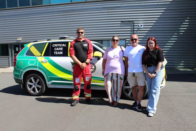 Marcus Johnson with Tanya, Simon and Ellen Brown by the rapid response vehicle in which he and the service's two doctors were travelling