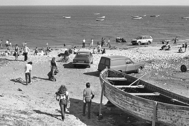 Beachgoers enjoying a summers day in Whitburn Beach in May 1979 in their 70s attire and even bringing their cars onto the beach. Can you remember cars being allowed on Whitburn Beach?