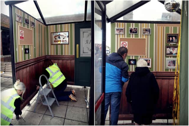 Artists Sally Southern and Nicola Lynch create the pop-up installation, while a couple look through the  many pictures