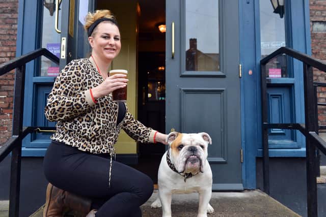 The medium has said the ghost which lives in the cellar of Helen Maddison's pub (pictured here with dog Bruce) does not like women.