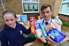 South Hylton Academy pupil Emily Benson, 11, with Head of School Chris Mitchinson and some of the items of surplus supermarket food. 

Picture by FRANk REID