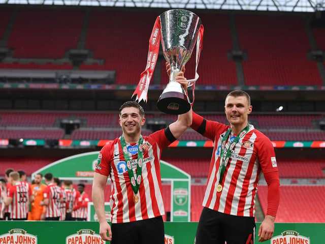 Lynden Gooch and Max Power of Sunderland celebrate with the Papa John's Trophy after the Papa John's Trophy Final match against Tranmere Rovers on March 14, 2021