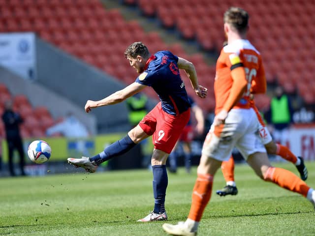Charlie Wyke sees a shot saved by Chris Maxwell