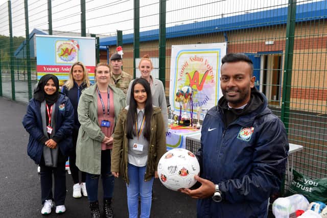 Young Asian Voices manager K. Ramanathas (Ram) with representatives at the anti-racism football event.