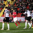 Charlton Athletic's Jayden Stockley (right) scores their side's second goal of the game, after a shot by team-mate Ben Purrington ricochets off his back during the Emirates FA Cup Second Round match at the Gateshead International Stadium. PA.