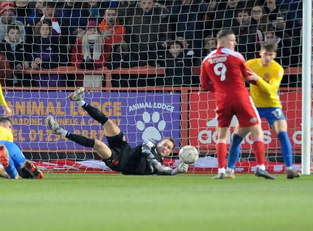 Thorben Hoffmann makes a save at Accrington Stanley