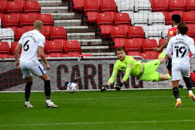 Lee Burge makes a save on his busiest afternoon of the season so far
