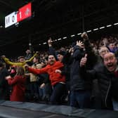 Sunderland fans celebrate their team's first goal during the English FA Cup fourth round football match between Fulham and Sunderland at Craven Cottage.
