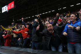 Sunderland fans celebrate their team's first goal during the English FA Cup fourth round football match between Fulham and Sunderland at Craven Cottage.