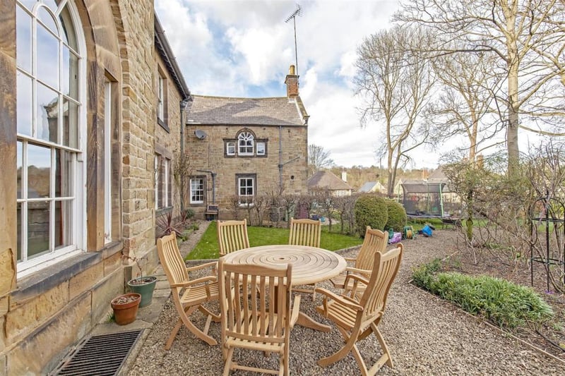Substantial mature and well-established gardens set behind original stone wall.