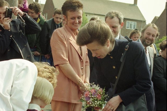 Six year old Lindsay Watson with Princess Anne after presenting the bouquet. Sharron Dixon, centre, looks on.