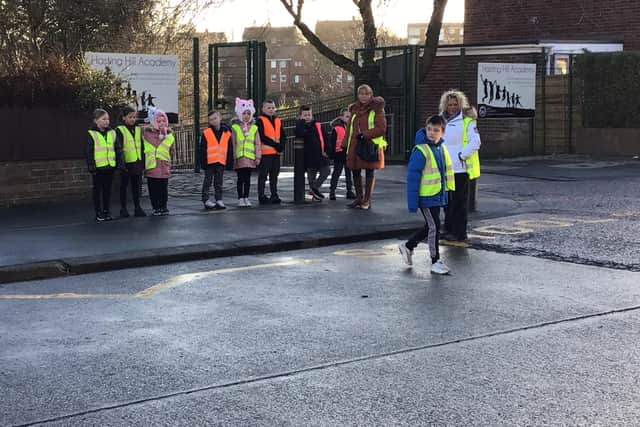 Children from Hasting Hill Academy learning to cross the road safely.