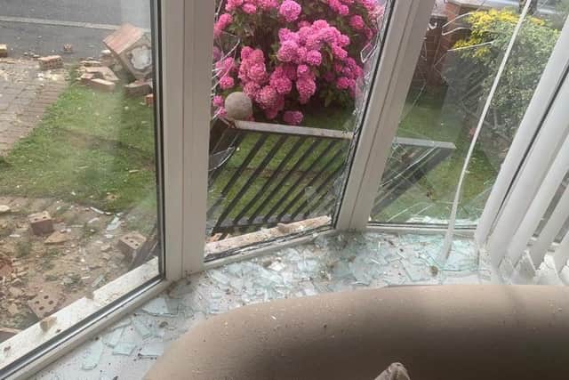The front window in the living room was left smashed.