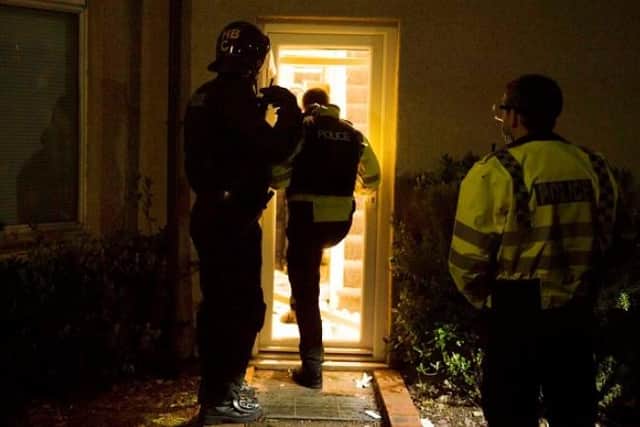 A photo from Thames Valley Police showing one of the raids it carried out across the country.