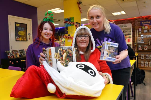 Geek Retreat Christmas toy appeal. From left Gemma Wilkinson, Gillian Pickes from Love Amelia charity and Laura Green.