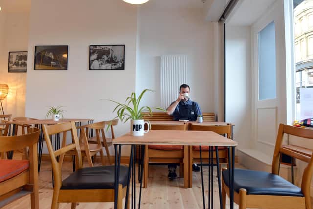 Dan Shannon, one of the directors inside the new Pop Recs Ltd coffee shop on High Street West.