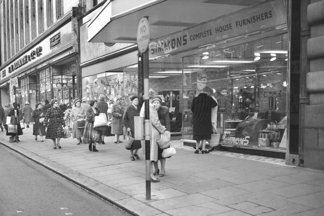 Shoppers in Fawcett Street, Sunderland look for Christmas bargains in 1960.