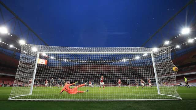 Pierre-Emerick Aubameyang scores from the penalty spot during the English Premier League football match between Arsenal and Leeds United. (Photo by CATHERINE IVILL/POOL/AFP via Getty Images)