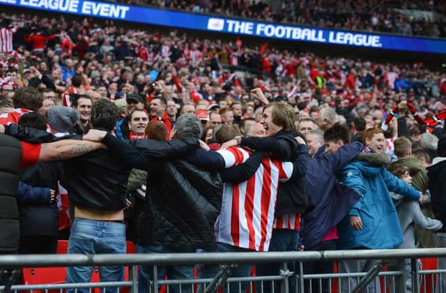 LONDON, ENGLAND - MARCH 02:  Sunderland fans celebrate during the Capital One Cup Final between Manchester City and Sunderland at Wembley Stadium on March 2, 2014 in London, England.  (Photo by Michael Regan/Getty Images)