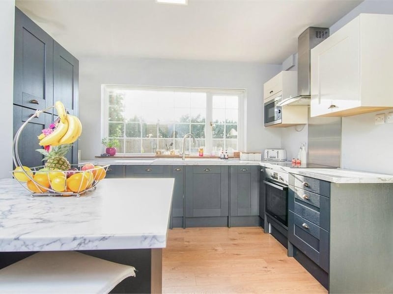The modern kitchen offers plenty of space and amenities, making it the perfect place to cook up a feast