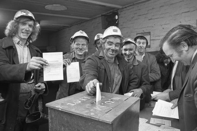 Miners at Easington Colliery cast their votes in a strike ballot on their way from the pit head to the baths at the end of their shift in 1974.