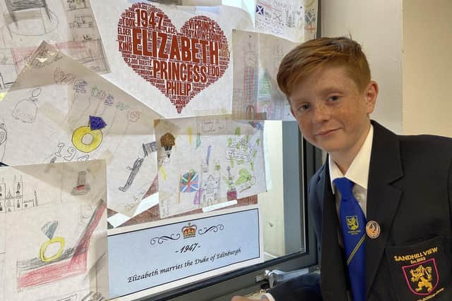 Year 7 pupil Preston Thubron, 11, with the timeline section he created about Queen Elizabeth's marriage to Prince Philip in 1947. 

Picture by FRANK REID