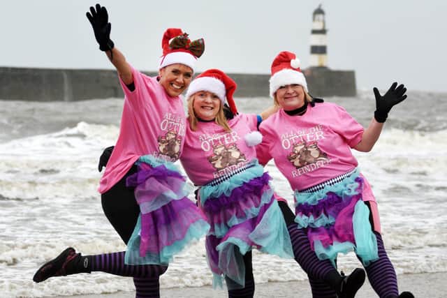 Debra Winter, Fiona Holmes and Janice Weeks ignore the stormy weather to take a Boxing Day dip at Seaham.