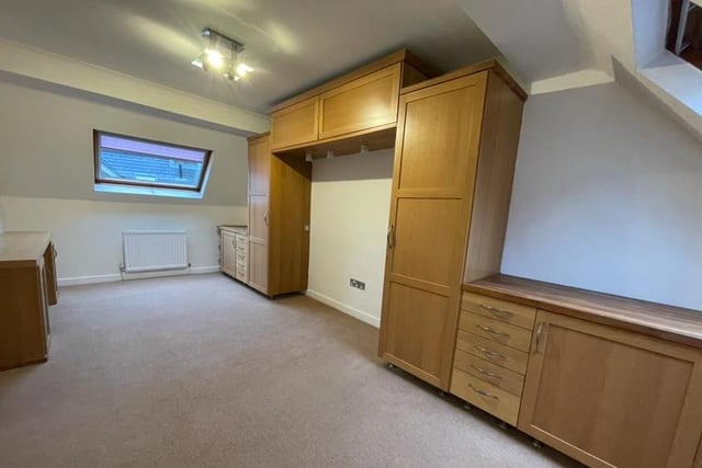 There is plenty of size and space to the second bedroom at the £350,000 property. It is fitted with an extensive range of built-in wardrobes with overhead cabinets and drawer units. There are Velux-style windows to the front and back, plus a central heating radiator.