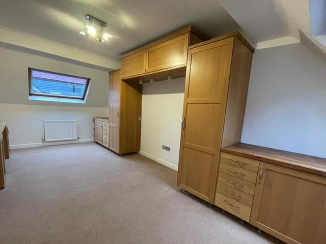 There is plenty of size and space to the second bedroom at the £350,000 property. It is fitted with an extensive range of built-in wardrobes with overhead cabinets and drawer units. There are Velux-style windows to the front and back, plus a central heating radiator.