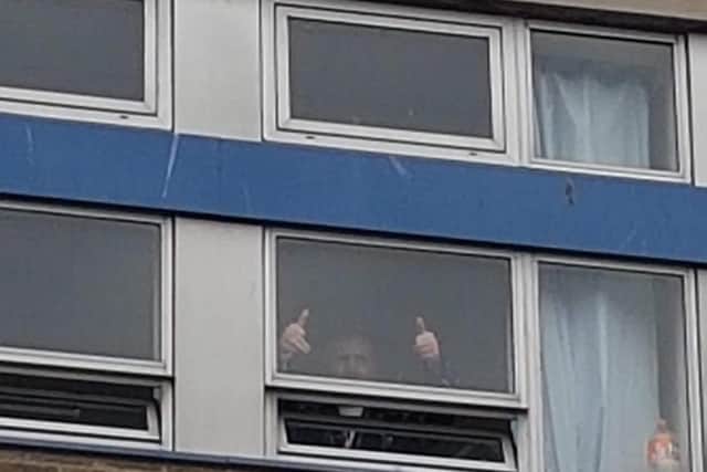 George McDermont gives thumbs up from the hospital window after beating Covid/Photo: Suzanne McDermont
