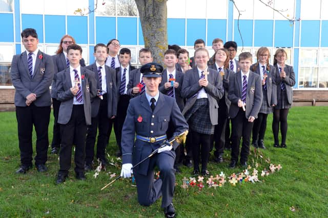 Former Monkwearmouth Academy student, flight officer Harry Loraine, with pupils holding some of their commemorative crosses.