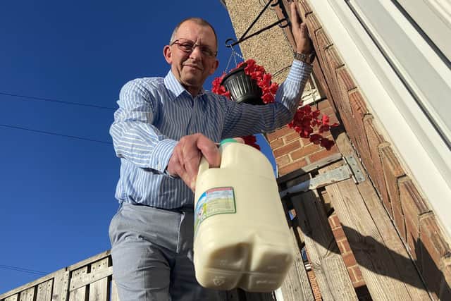 John Amer delivering milk - just as he has done without missing a day for 34 years.