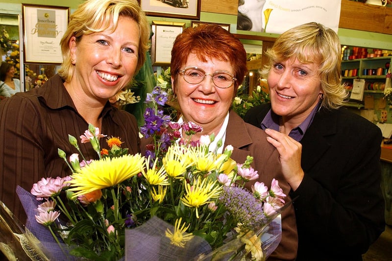 Discover the Spirit winner Valerie Lepedat (centre) receives a bouquet of flowers from Andrea Wood (left), of Woods florists, watched by Alison Billups, of the Aurora Centre Charity Group in 2004