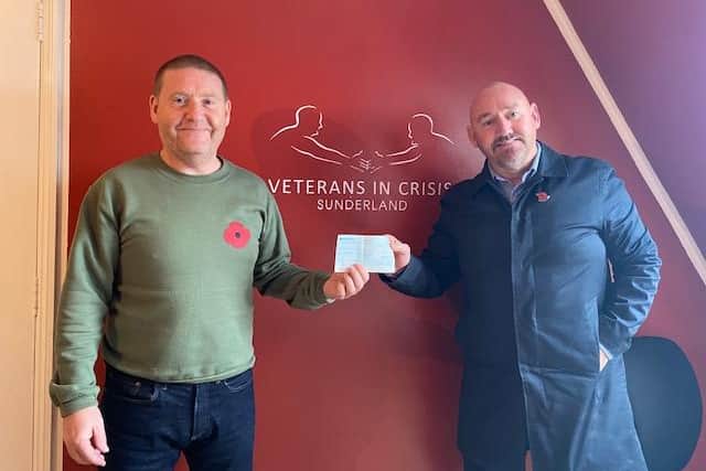 Tom Cuthbertson, right, make a Veterans' Walk donation to Ger Fowler of Veterans in Crisis