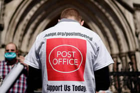 A supporter celebrates outside the Royal Courts of Justice in London in 2021 following a court ruling clearing subpostmasters of convictions for theft and false accounting. Photo by Tolga Akmen / AFP via Getty Images