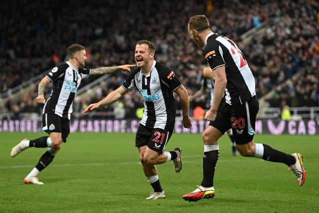 Ryan Fraser of Newcastle United celebrates with team mate Chris Wood after scoring their sides second goal during the Premier League match between Newcastle United and Everton at St. James Park on February 08, 2022 in Newcastle upon Tyne, England. (Photo by Stu Forster/Getty Images)