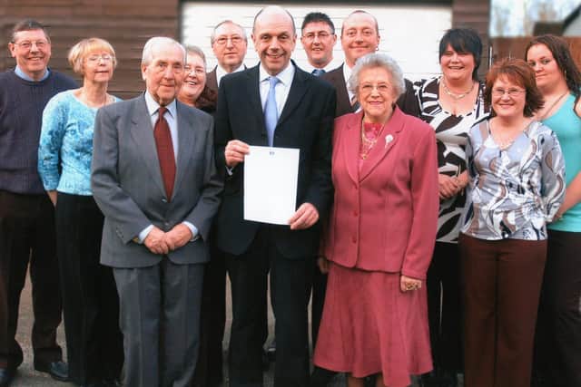 Joyce and Sam Blackburn flank Houghton and Washington East MP Fraser Kemp as he holds the letter the couple received from Tony Blair, watched by family members
