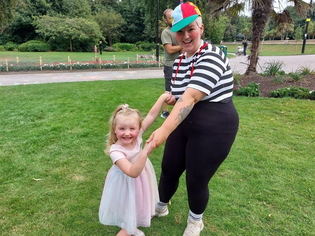 Lauren Baillie and Delilah Black, aged three, having a dance in the park.