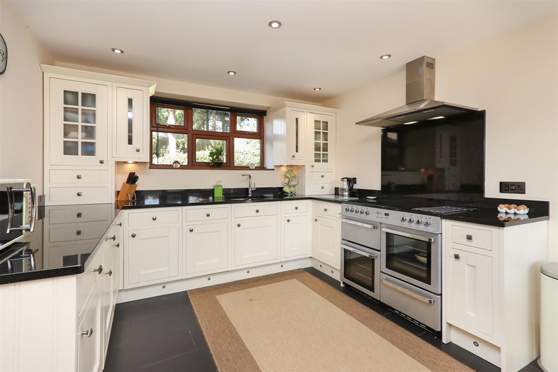 Farmhouse-style dining kitchen with solid granite worktops and patio doors to garden.