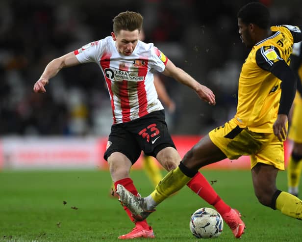 SUNDERLAND, ENGLAND - JANUARY 11: Denver Hume of Sunderland in action during the Sky Bet League One match between Sunderland and Lincoln City at Stadium of Light on January 11, 2022 in Sunderland, England. (Photo by Stu Forster/Getty Images)