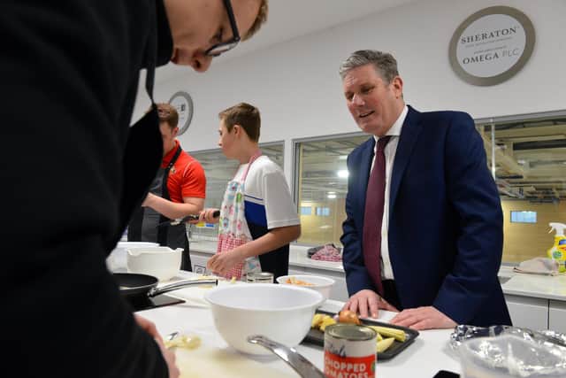 Labour leader Sir Keir Starmer chats with youngsters taking part in a cookery session at the Beacon Light.