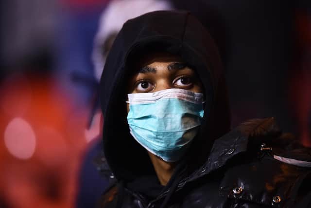 NOTTINGHAM, ENGLAND - MARCH 06: A fan wears a face mask as protection from Coronavirus during the Sky Bet Championship match between Nottingham Forest and Millwall at City Ground on March 06, 2020 in Nottingham, England. (Photo by Nathan Stirk/Getty Images)