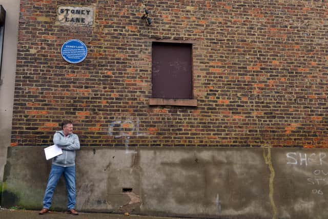 Peter Gibson with the new blue plaque on  Stoney Lane, once a wagonway linking the quarries to the riverside kilns.