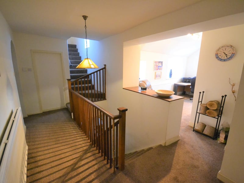 There is a large, double-panel radiator and open-plan access to the study.