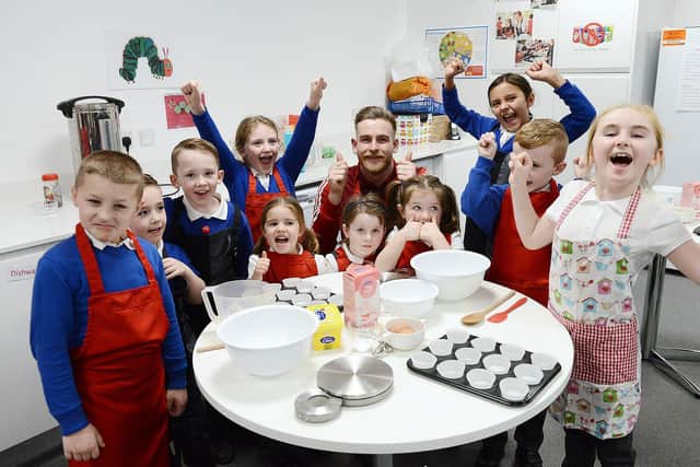 Sunderland AFC goalkeeper Lee Burge poses for a photograph before baking cakes with children during the EFL Day of Action held at the Beacon of Light.