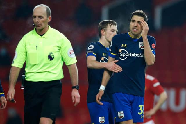 Jan Bednarek argues with Mike Dean, the match referee during the Premier League match between Manchester United and Southampton.
